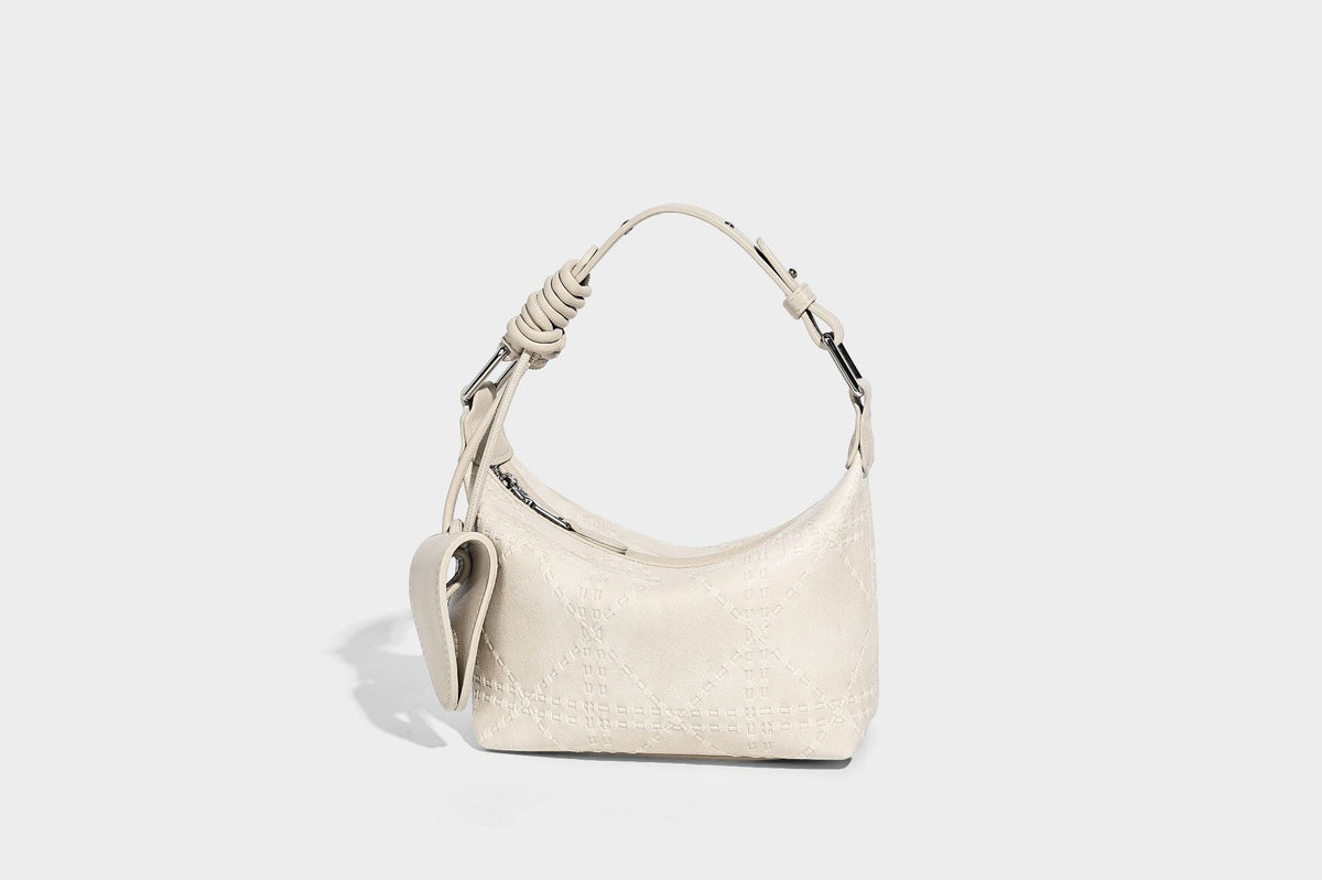 Small embossed half-moon shoulder bag with top zipper, detachable front pouch, and adjustable slim strap, detail view 14