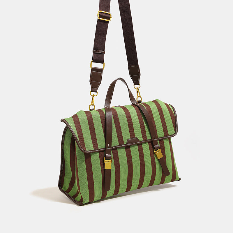 Structured striped canvas convertible satchel bag with leather-look trim, gold-tone buckle hardware, and backpack straps