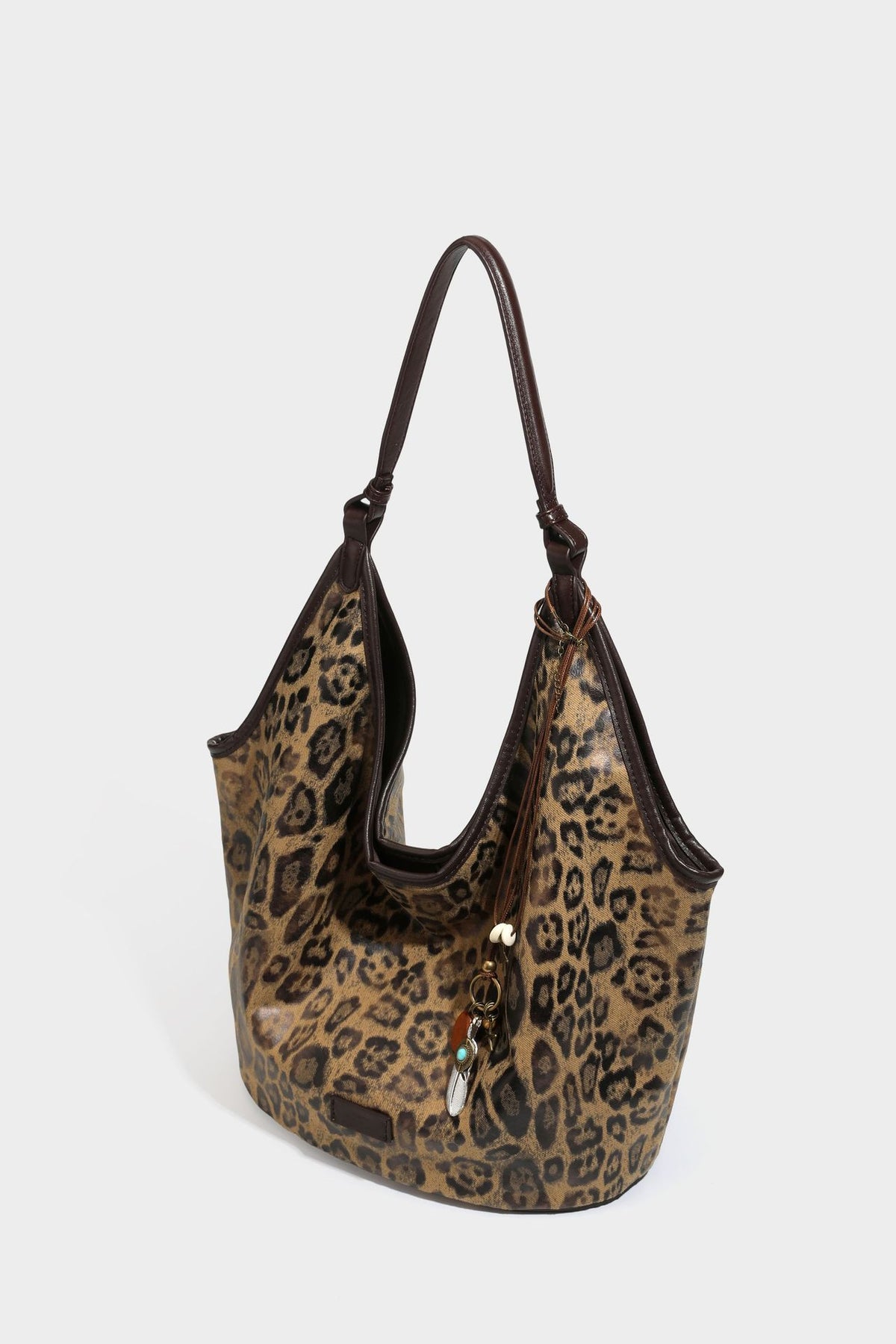 Large slouchy leopard-print shoulder tote bag with glossy tan-and-brown finish, dark brown leather-look trim, single