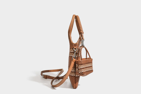 Color-block woven tote bag with rounded leather-look handles, detachable crossbody strap, and matching mini clip-on pouch in