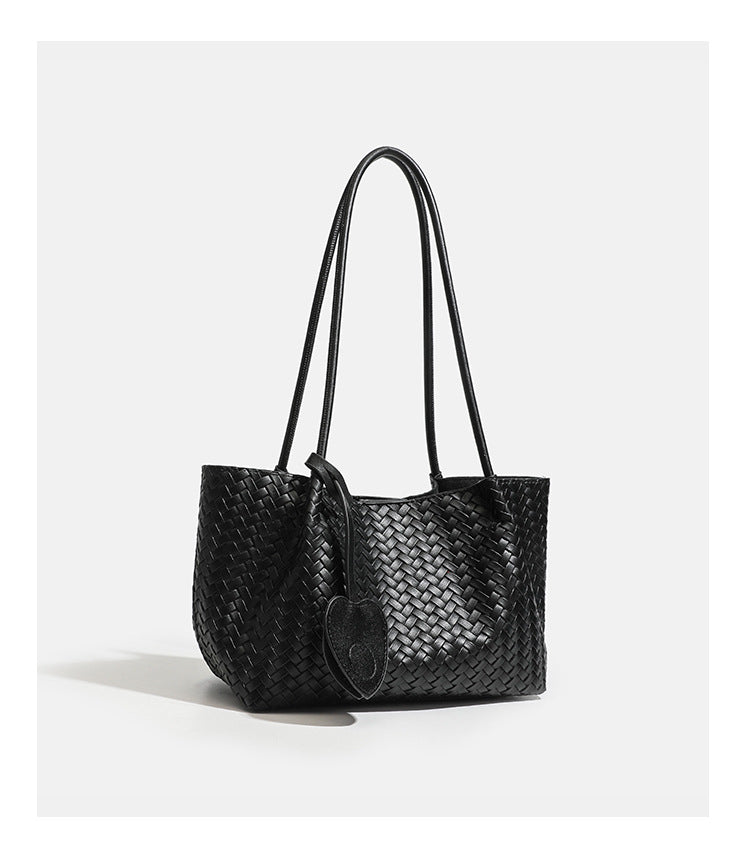 Woven leather-look tote bag in yellow with long shoulder straps, heart-shaped hanging charm, and removable inner zip pouch