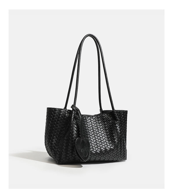 Woven leather-look tote bag in yellow with long shoulder straps, heart-shaped hanging charm, and removable inner zip pouch