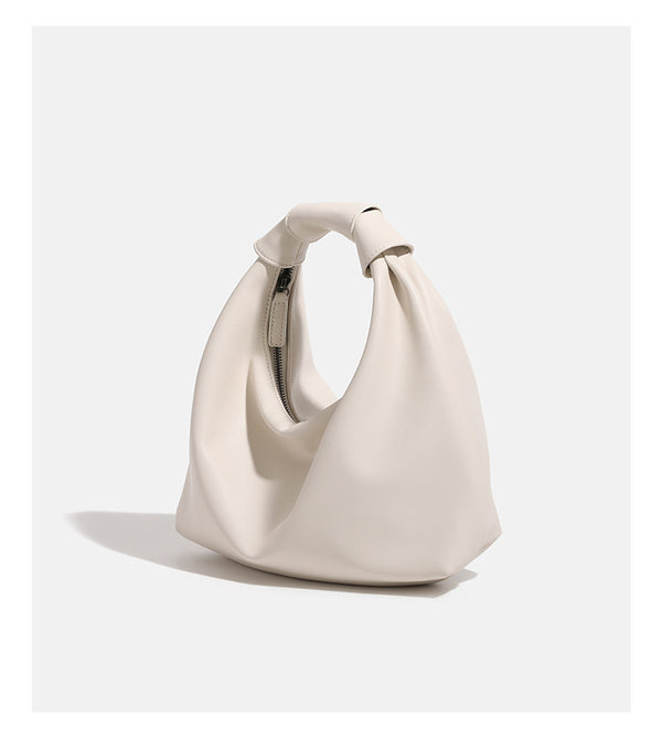 Slouchy leather-look hobo bag with knotted loop handle and top zipper closure, detail view 12
