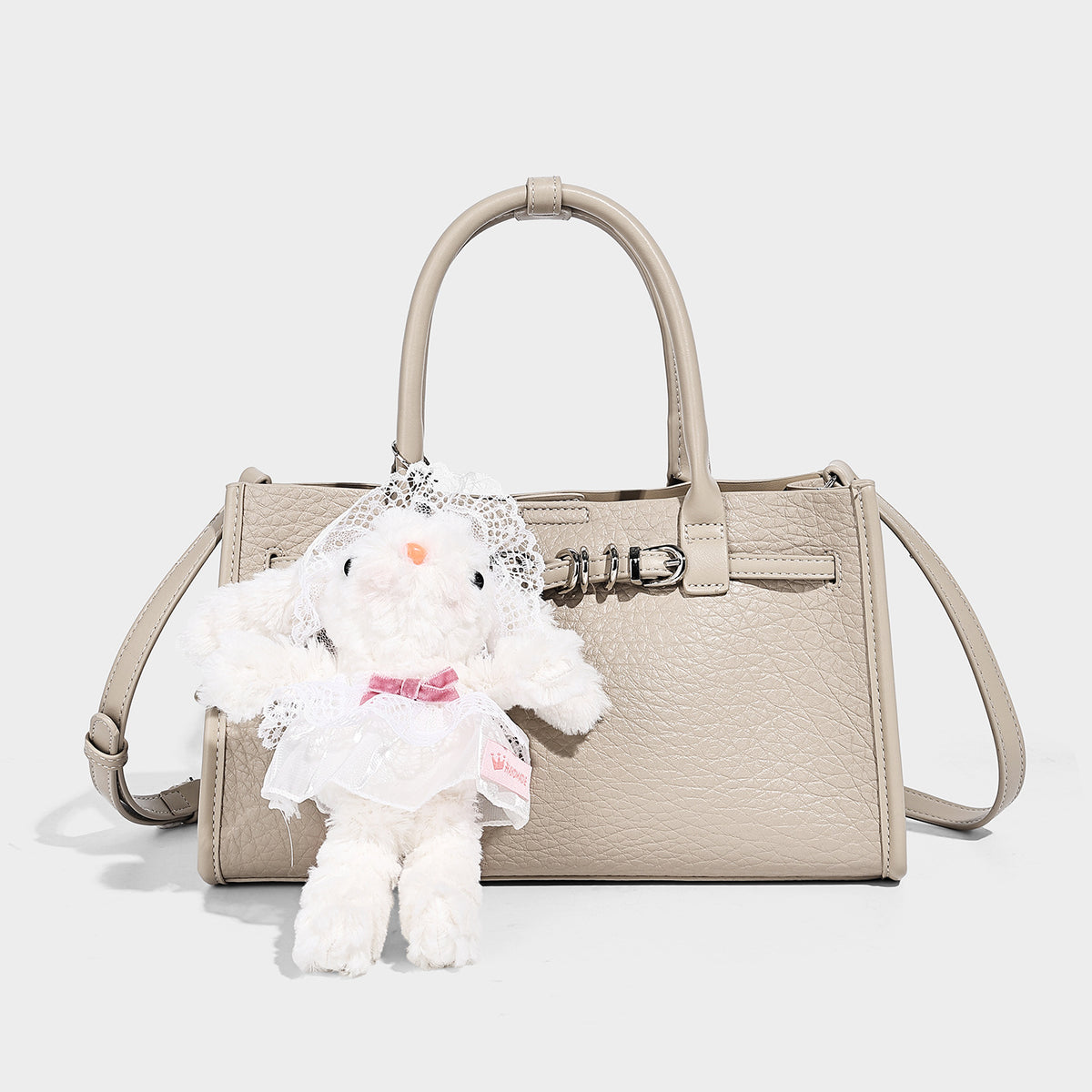 Structured trapezoid tote bag in pebbled leather-look finish with double top handles, silver-tone bar hardware, and, detail