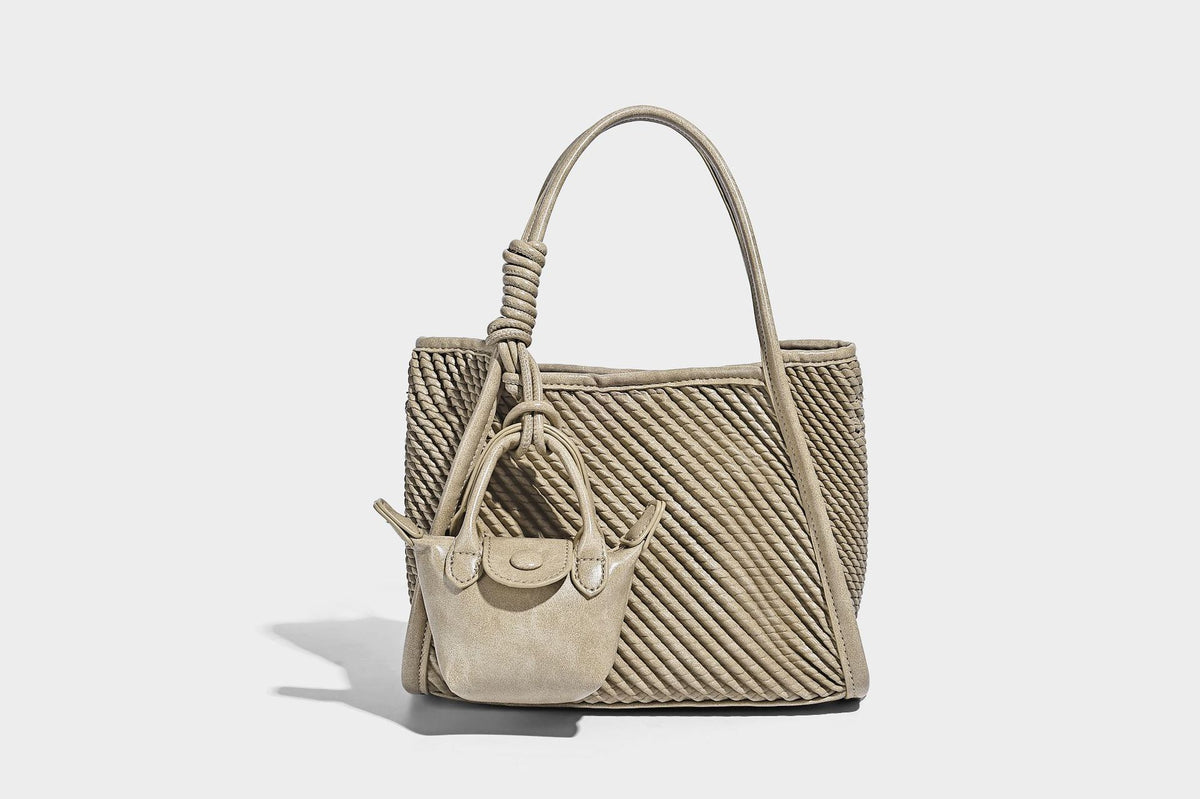 Large structured woven rope-texture tote bag with smooth leather-look trim, knotted dual top handles, detachable mini front