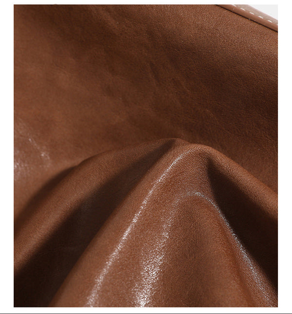 Structured leather-look flap backpack handbag with top handle, buckle front straps, white contrast stitching, and gold-tone