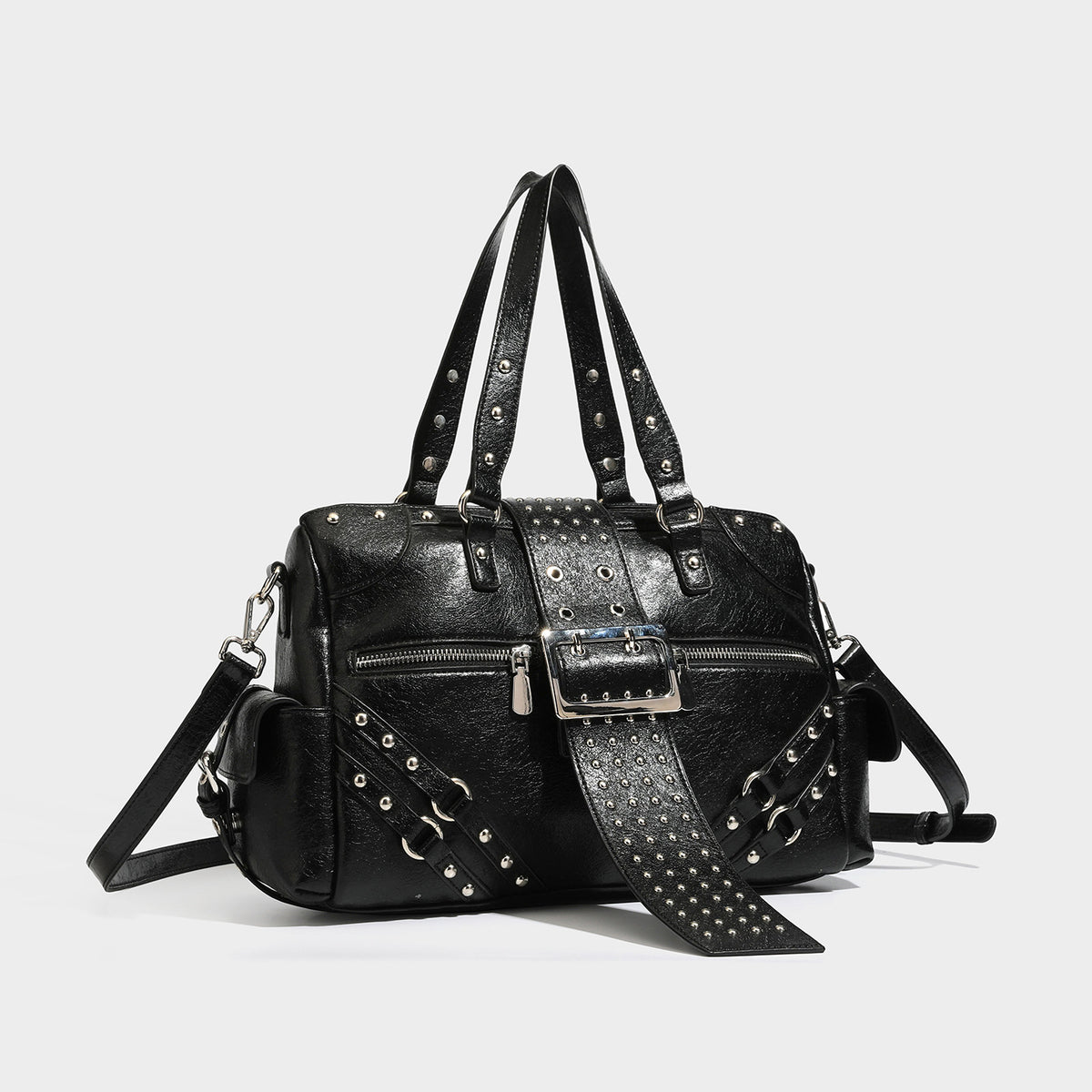 Structured pink leather-look satchel bag with gunmetal studded trim, rectangular buckle strap, dual top handles, and, detail