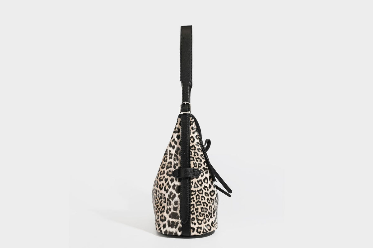 Slouchy leopard print shoulder hobo bag with black leather-look trim, tie-top closure, and single long strap, detail view 30