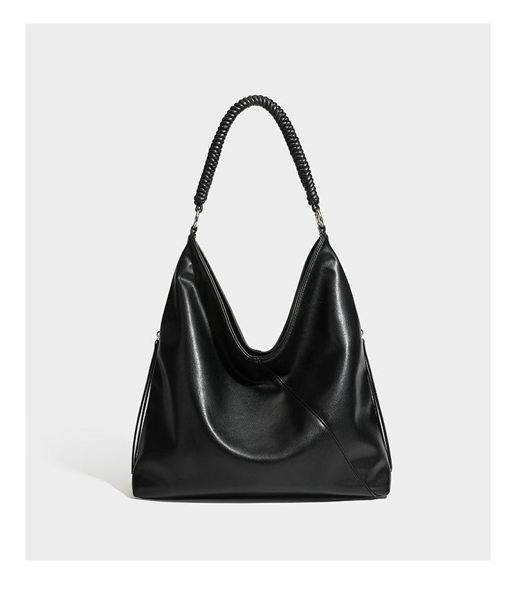 Large slouchy hobo shoulder bag with braided top handle, smooth glossy leather-look finish, and silver-tone ring hardware