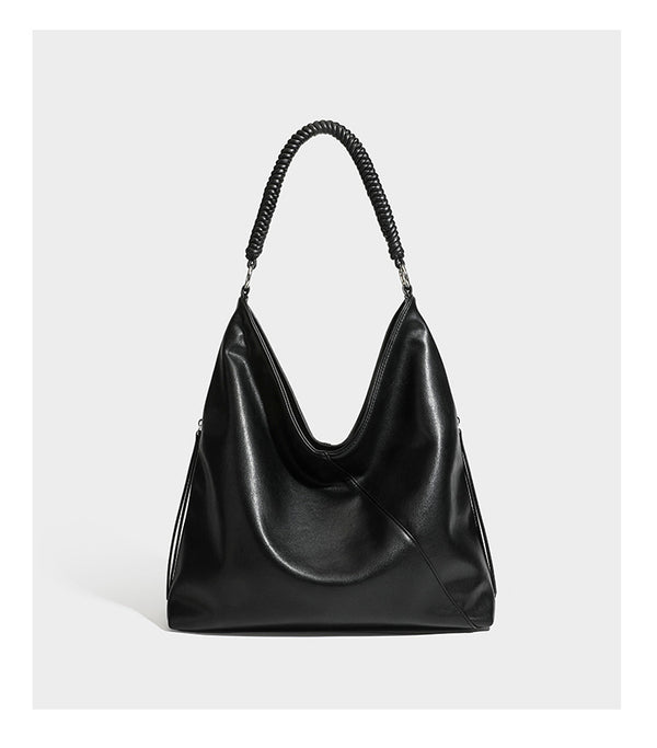 Large slouchy hobo shoulder bag with braided top handle, smooth glossy leather-look finish, and silver-tone ring hardware
