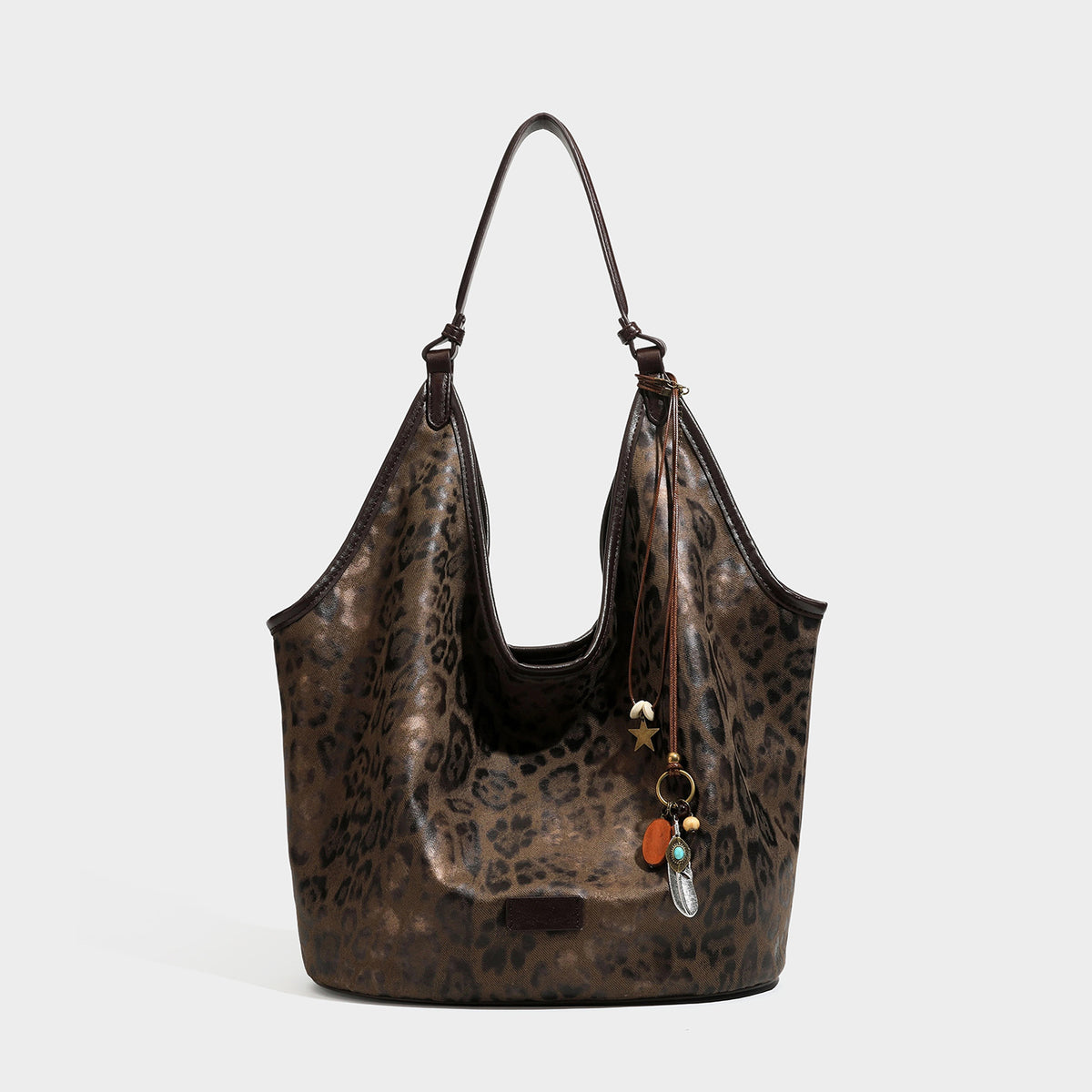 Large slouchy leopard-print shoulder tote bag with glossy tan-and-brown finish, dark brown leather-look trim, single