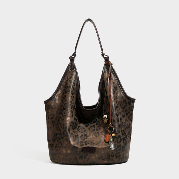Large slouchy leopard-print shoulder tote bag with glossy tan-and-brown finish, dark brown leather-look trim, single
