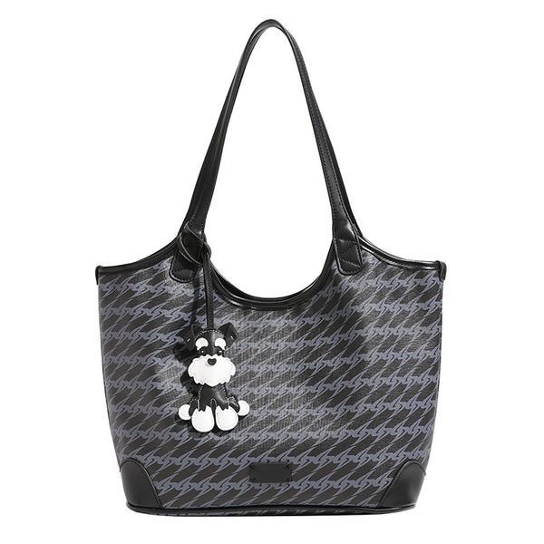 Large black monogram tote bag with tonal grey repeat print, leather-look trim, and black-and-white schnauzer bag charm