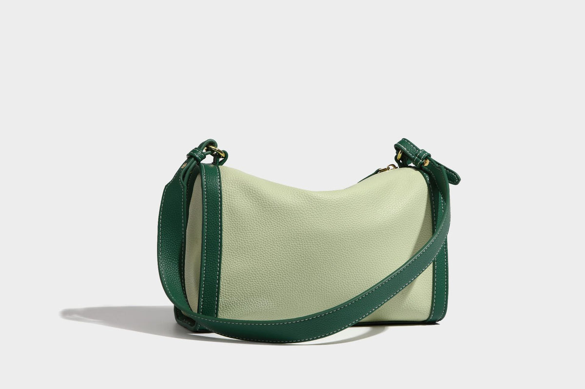 Structured two-tone shoulder bag with pebbled leather-look finish, contrast trim, top zip closure, and gold-tone hardware