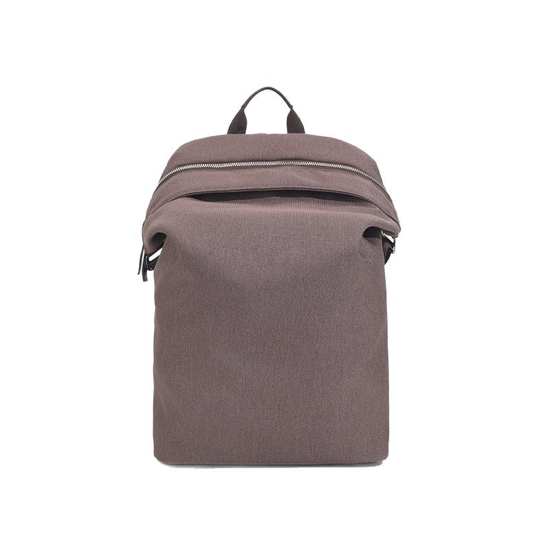 Structured matte nylon backpack with top zip closure, front zip pocket, top carry handle, and adjustable shoulder straps