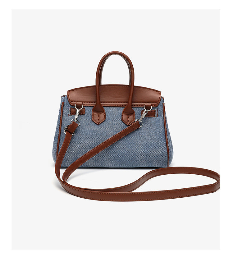 Small structured trapezoid satchel bag with smiling face motif, pom-pom accents, brown leather-look trim, silver-tone, detail