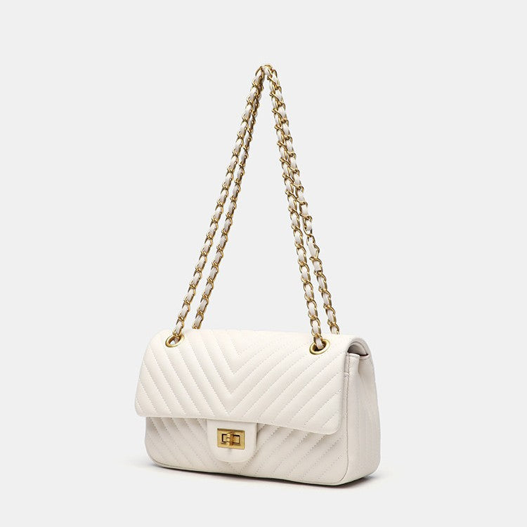 Structured quilted flap bag with gold-tone chain strap and turn-lock closure, front view