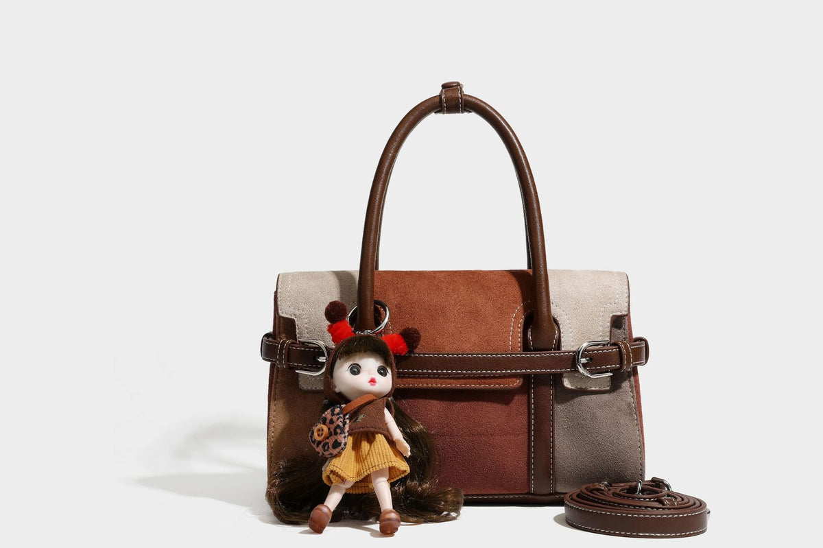 Structured color-block satchel bag in brown, rust, beige, and taupe suede-look panels with white topstitching, front buckle