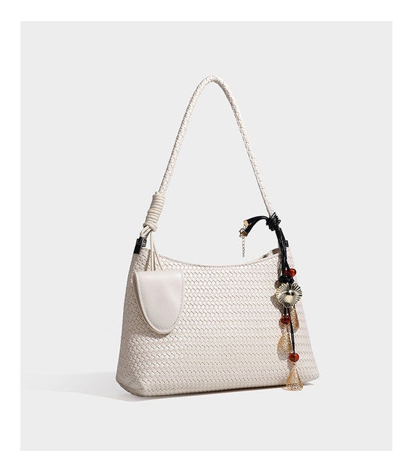 Woven-texture hobo shoulder bag in brown with braided top handle, adjustable crossbody strap, front flap pocket, and, detail