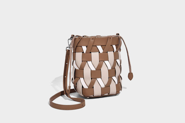 Small woven lattice bucket bag in tan and cream leather-look strips with drawstring top and detachable crossbody strap