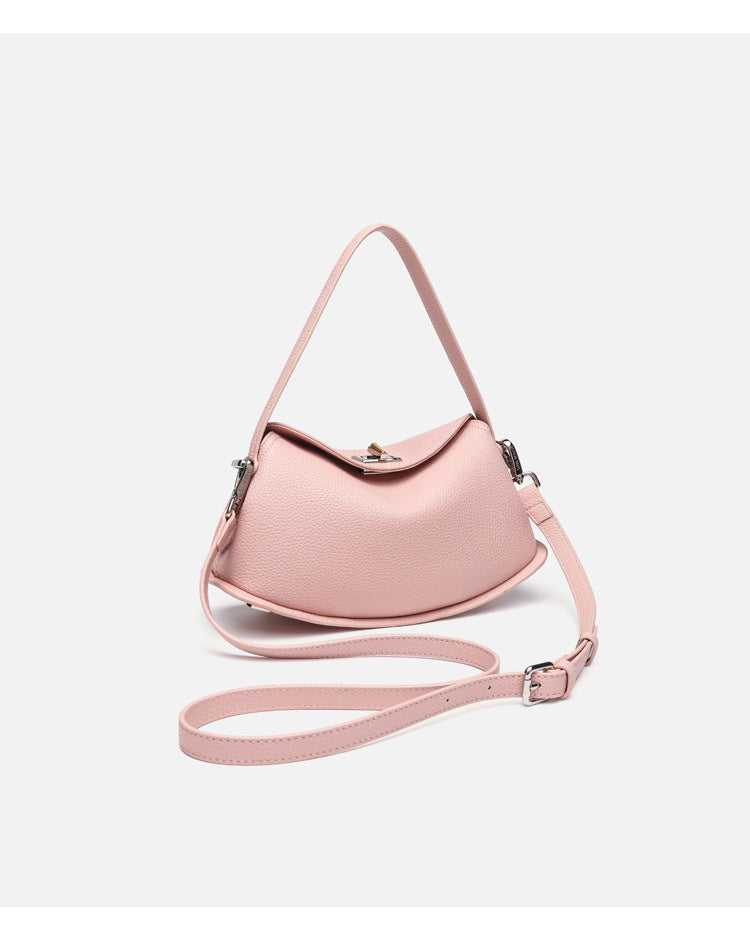 Pebbled leather-look half-moon saddle bag with turn-lock flap closure, top handle, and detachable crossbody strap, detail