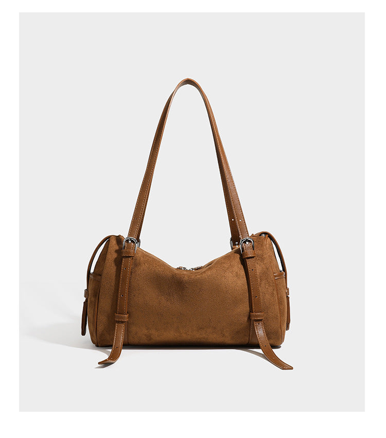 Large brown suede-finish barrel shoulder bag with dark leather-look trim, silver-tone zippers, dual top handles, and long