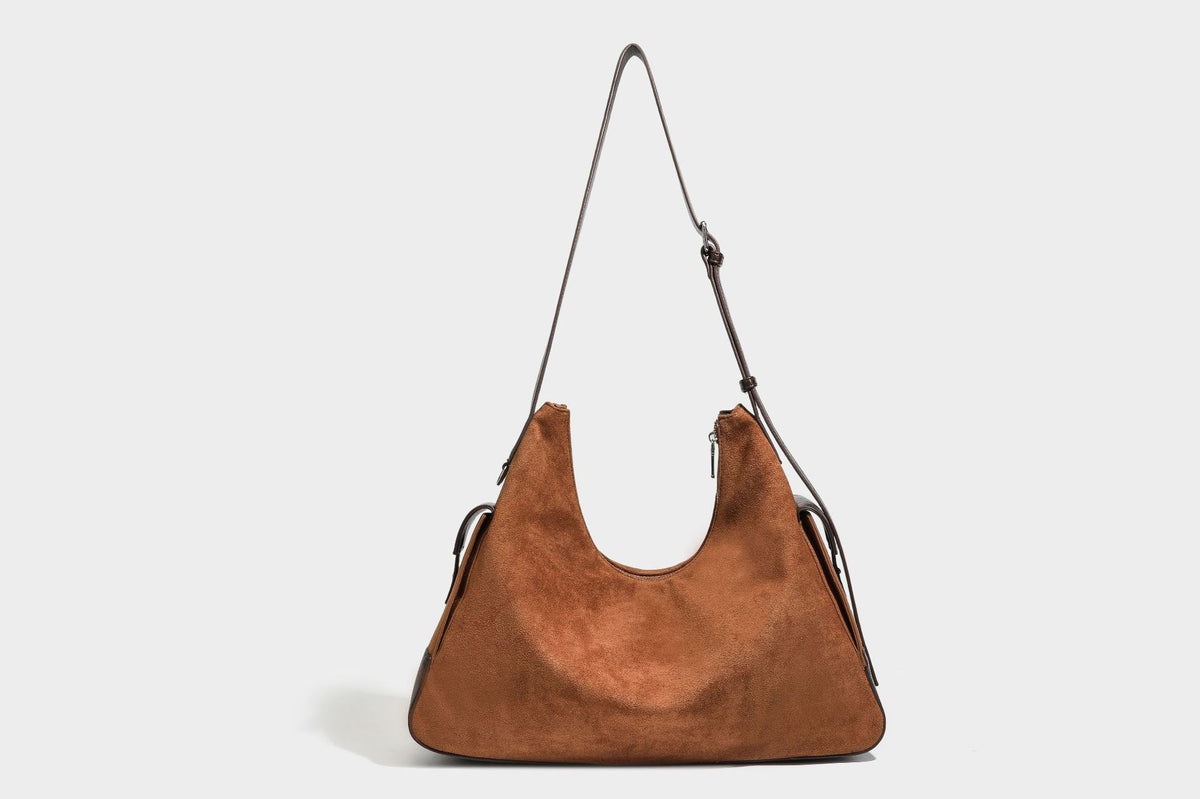 Slouchy cognac brown matte suede-look hobo shoulder bag with dark brown leather-look trim, top zip closure, front flap