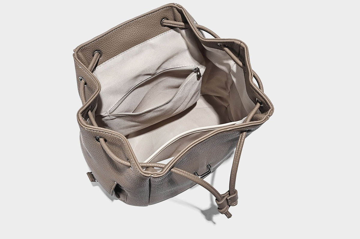 Compact pebbled leather-look flap drawstring backpack handbag with side pockets, top handle, and silver-tone hardware, detail