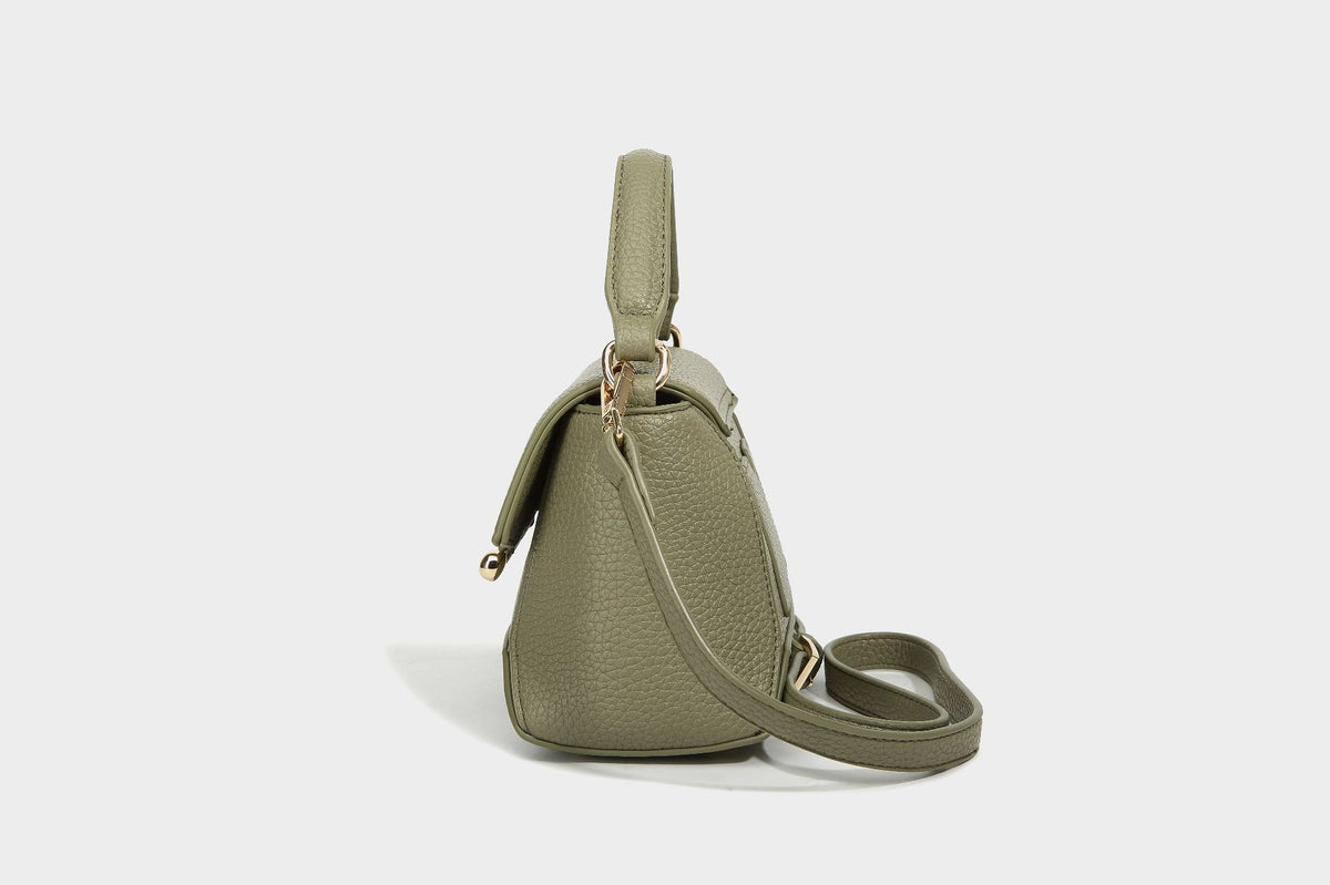 Small structured pebbled flap mini satchel with gold-tone bar hardware, short top handle, and detachable crossbody strap