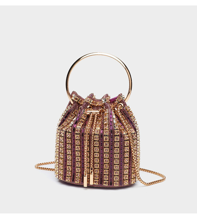 Mini crystal rhinestone bucket bag with circular ring top handle, drawstring closure, and silver chain shoulder strap, detail