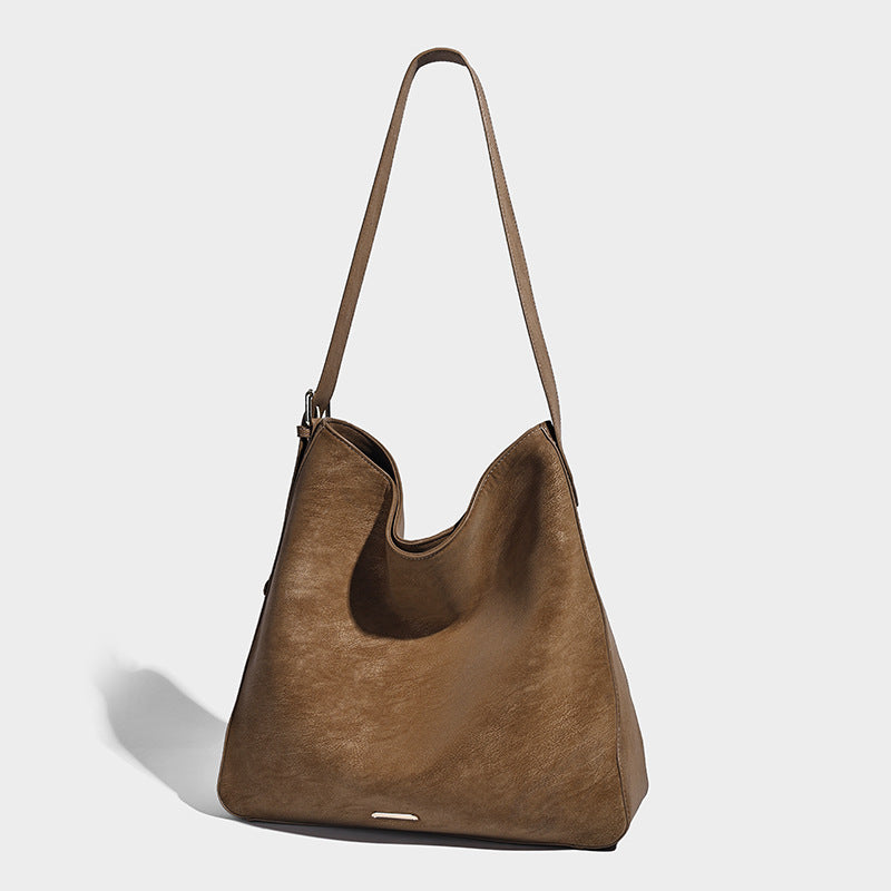Large slouchy hobo shoulder bag in matte leather-look finish with adjustable strap and gold-tone bar hardware, detail view 8