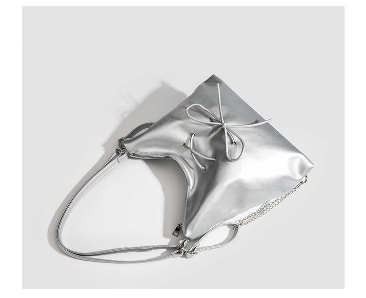 Glossy leather-look hobo shoulder bag with front bow lacing detail and silver-tone chain strap, detail view 25