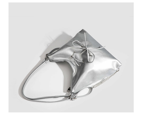 Glossy leather-look hobo shoulder bag with front bow lacing detail and silver-tone chain strap, detail view 25