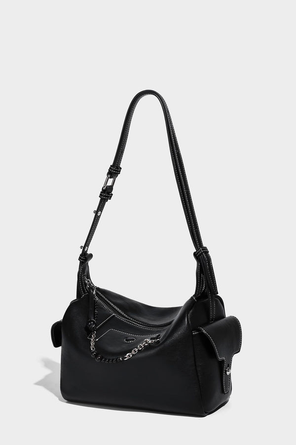 Small slouchy moto-style crossbody bag in smooth matte leather-look finish with white contrast stitching, silver-tone, detail