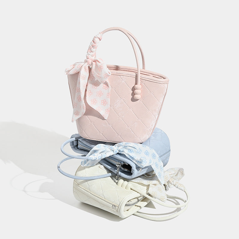 Quilted leather-look mini tote bag with printed scarf bow on braided top handle and silver-tone hardware, detail view 2
