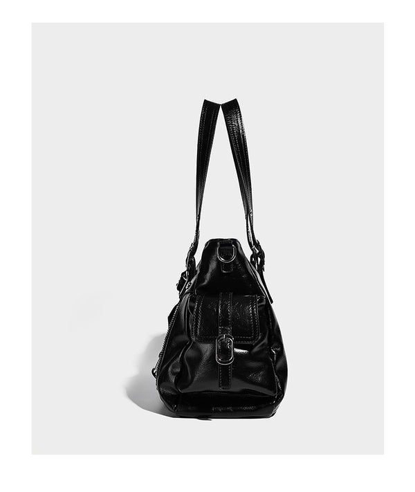 Glossy structured black tote shoulder bag with silver buckle hardware, zip pockets, dual top handles, and detachable, detail