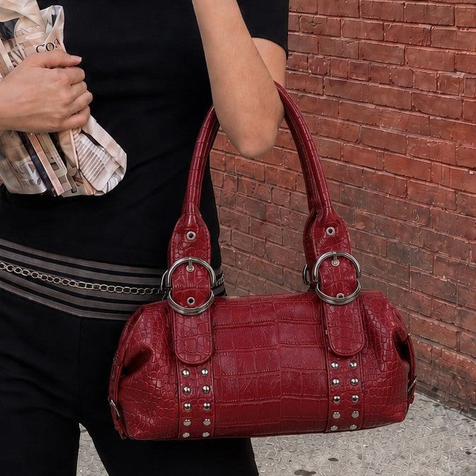 Croc-embossed leather-look barrel satchel bag with silver ring buckle hardware and stud panel trim, front view