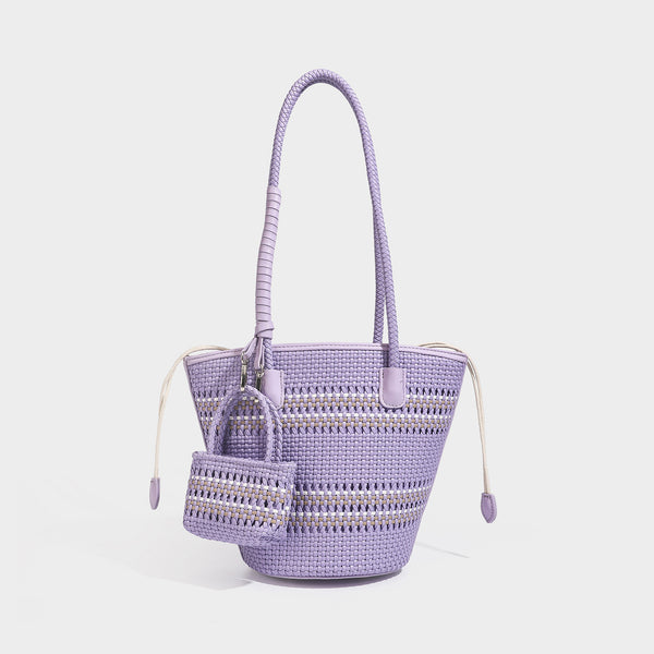 Structured woven bucket tote bag in pastel blue with braided shoulder strap, open lattice weave body, cream drawstring