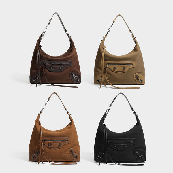 Slouchy suede-finish hobo shoulder bag with dark hardware, exterior zip pocket, tassel ties, and detachable crossbody strap