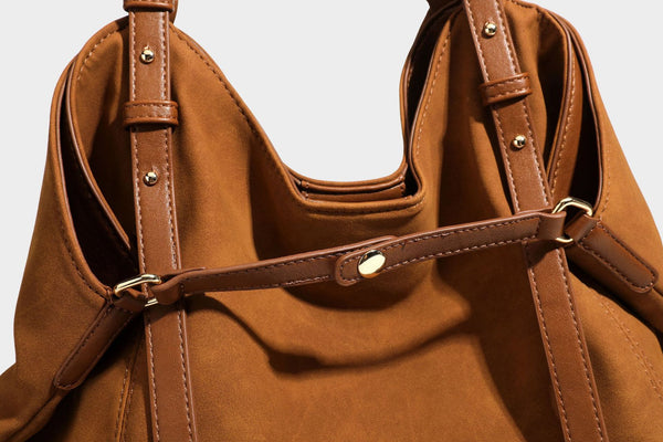 Oversized suede-finish tote shoulder bag in caramel brown with slim leather-look straps and gold-tone logo hardware, detail