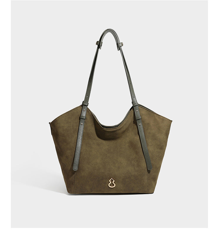 Oversized suede-finish tote shoulder bag in caramel brown with slim leather-look straps and gold-tone logo hardware, detail