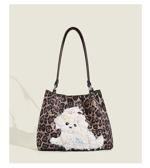 Leopard-print fabric tote bag with white plush teddy bear appliqué and brown leather-look shoulder straps, detail view 9