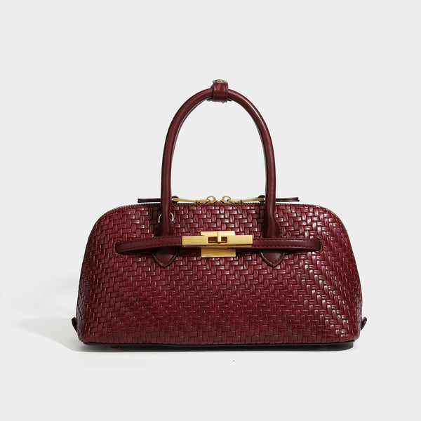 Structured woven-embossed leather-look satchel with dual rolled top handles, gold-tone turn-lock closure, and detachable