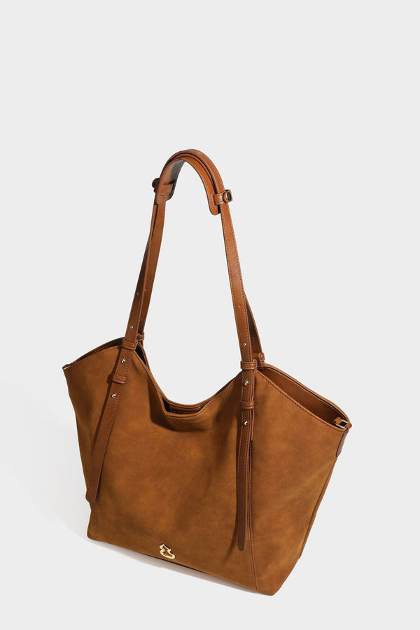 Oversized suede-finish tote shoulder bag in caramel brown with slim leather-look straps and gold-tone logo hardware, detail