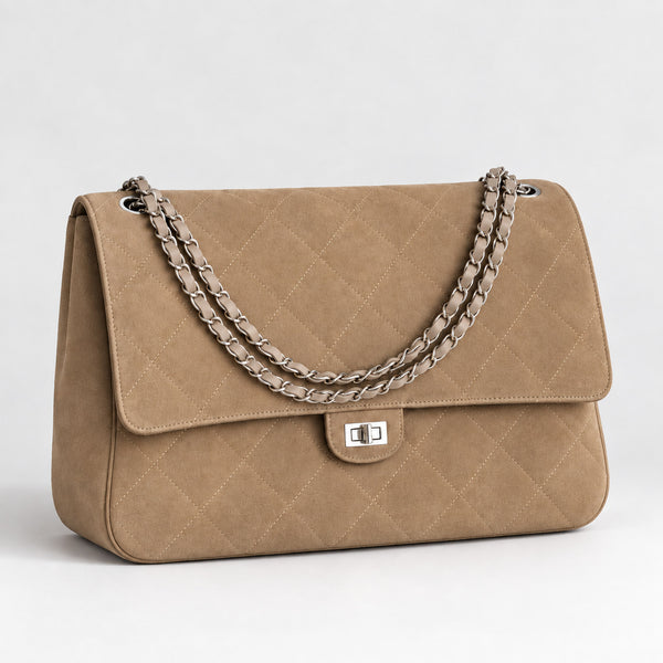 Quilted diamond-stitch flap shoulder bag with double silver chain strap and turn-lock closure in suede-look finish, detail