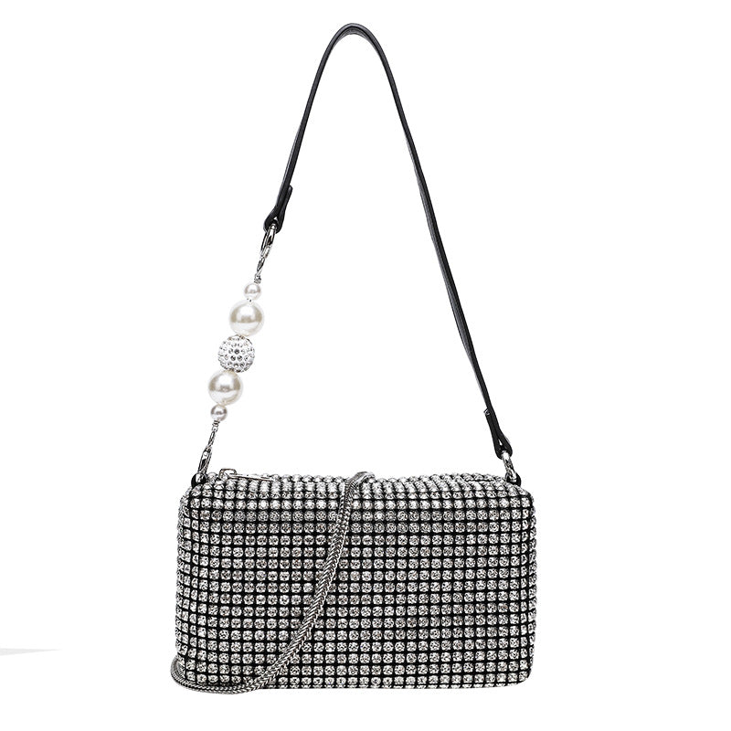 Small rectangular all-over rhinestone crossbody bag with pearl bead zipper pull and detachable silver chain strap, detail