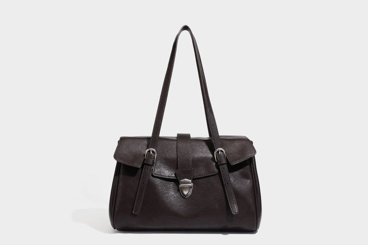 Large structured vintage-style tote bag with flap-front turn-lock closure, twin buckle straps, and double shoulder handles