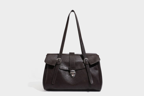 Large structured vintage-style tote bag with flap-front turn-lock closure, twin buckle straps, and double shoulder handles