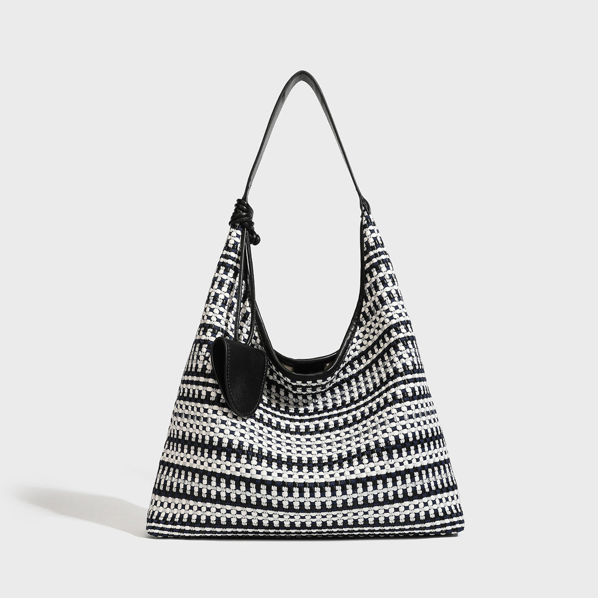 Slouchy woven stripe hobo shoulder bag with black-and-white pattern and leather-look strap, detail view 4