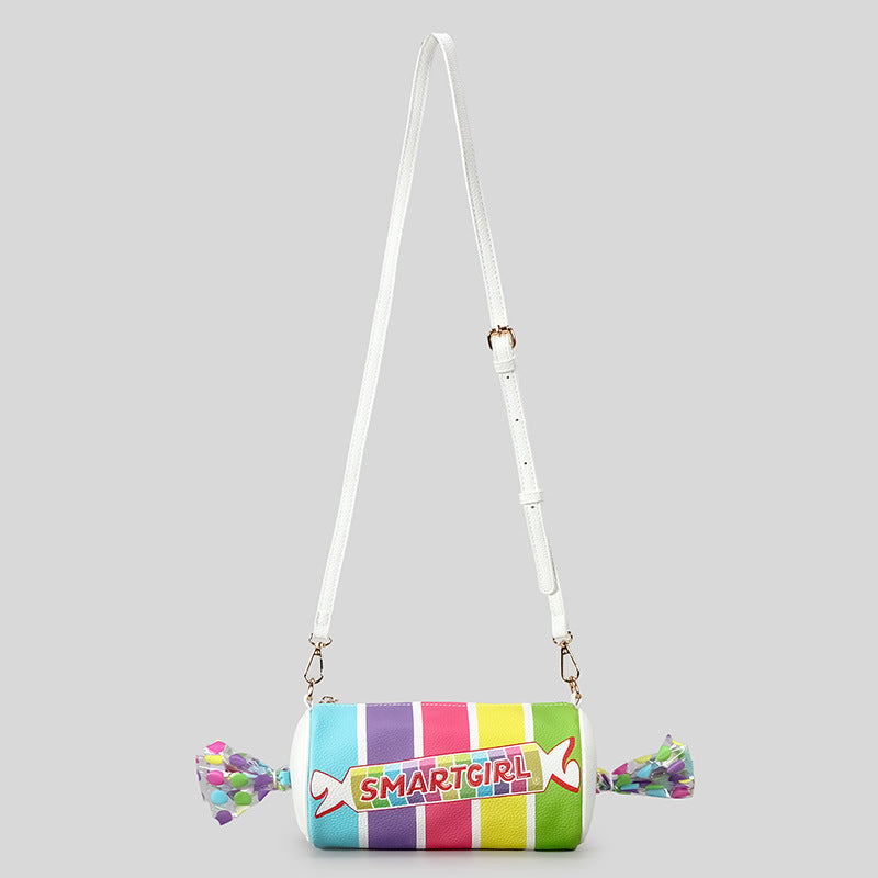 Rainbow striped candy barrel crossbody bag with clear twist ends, white adjustable strap, and gold-tone hardware, detail view